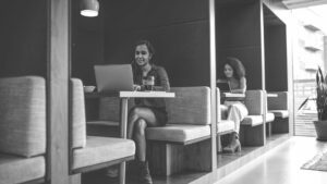 Two women working in coworking office hubs