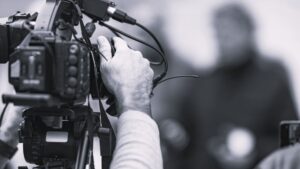 Closeup of cameraman at news conference