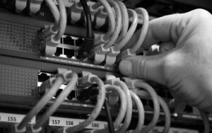 Man's hand testing network cables