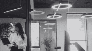 Business woman in office with commercial lighting